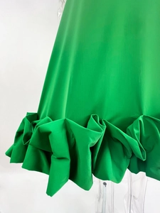 Detailed view of the layered ruffle hem on this vibrant green A-line evening dress