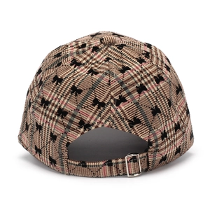 Close-up of baseball cap back with pink plaid fabric, bow print and metal buckle