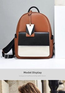 Detail of a tri-color contrast leather backpack with front pocket and triangle charm