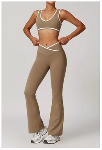 Detail of cross-waist design and contrast piping on high-waist yoga flared leggings