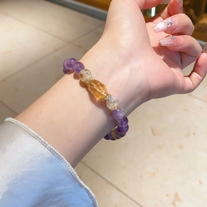Detailed close-up of amethyst and citrine beaded bracelet with gold zircon spacers