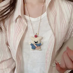 Handmade plush bear pendant necklace with colorful beads and striped fabric clothing