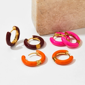 Three pairs of enamel hoop earrings in deep red, bright pink, and orange with gold metal