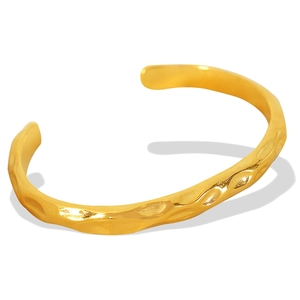 Golden irregular hammered texture open bangle bracelet with a minimalist vintage design
