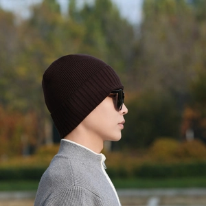 Winter knitted wool beanie in dark brown featuring a thick ribbed thermal design