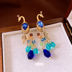 Vintage peacock tassel earrings with blue crystals and colorful beads in gold finish