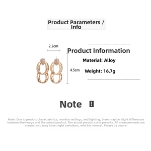Detailed view of gold oval drop earrings with hammered texture and white crystals