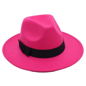 Detail of rose pink fedora hat with wide brim, featuring a black ribbon bow decoration