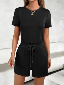 Front view of a casual black short-sleeve romper with drawstring waist and side pockets