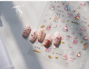 Macro detail of TL-282 pink Christmas bear nail stickers with gold foil tree and snowflake