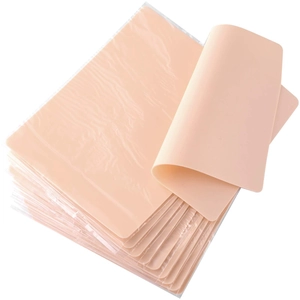 Pink silicone tattoo practice skins in rectangular sheets for professional training