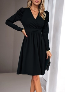 Detail of elegant black V-neck dress featuring puff sleeves and pleated waistline