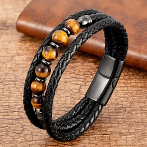 Detail of multi-layer men's leather bracelet with brown tiger eye beads and magnetic clasp