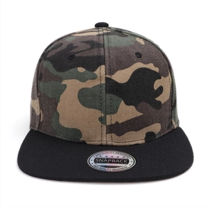 Detailed view of camouflage snapback hat with flat black brim and high quality silver seal