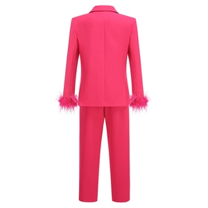 Rear view of pink two-piece suit with ostrich feather cuffs and sleek trousers
