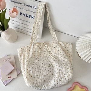 Detail of floral chiffon tote bag featuring a decorative bow tie and soft fabric texture