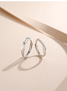 Macro view of S925 sterling silver couple rings featuring a twisted design and zircon inlay