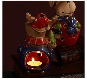 Detailed view of ceramic reindeer candle holders with warm tea light glow and cutout stars