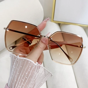 Oversized rimless sunglasses with brown gradient lenses and slim gold metal frame