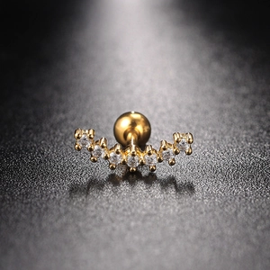 Detailed macro view of gold-plated curved cartilage stud with 7 sparkling cubic zirconia