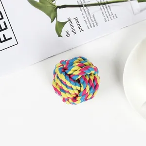 Macro detail of multi-color braided cotton rope ball toy for pets in a studio setting