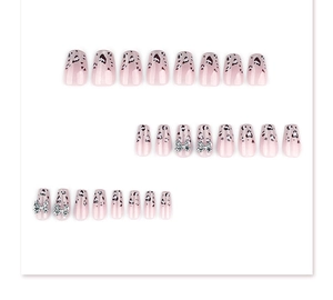 Short trapezoid press-on nails with leopard print, hearts and silver bow charms