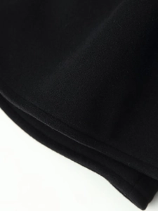 Macro detail of high-quality black wool fabric texture and stitching on hooded coat