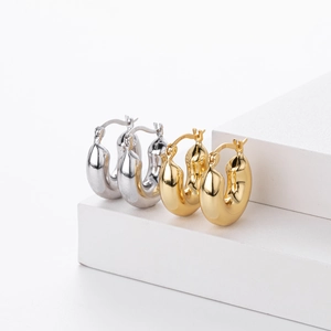 Polished S925 sterling silver and gold thick hoop earrings in a minimalist style