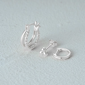 Detailed macro view of S925 sterling silver earring set including hoop and stud
