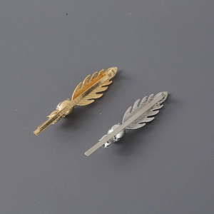 Elegant gold and silver feather-shaped hair clips with delicate rhinestone and pearl accents