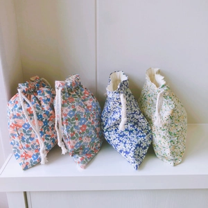 Set of four Korean floral cotton drawstring storage bags in various pastel patterns