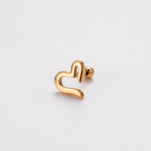 Macro view of a gold heart-shaped stud earring with a spherical screw-back design