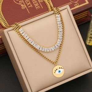 Double-layered gold necklace with blue eye pendant and zircon on vintage book display