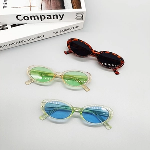 Flat lay of vintage oval sunglasses in leopard and colorful frames on modern background