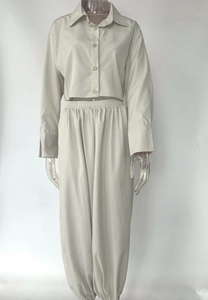 Detailed view of beige three-piece lounge set with cropped button-up shirt and jogger pants
