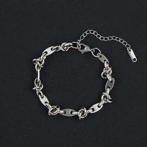 Detailed macro of vintage silver oval links with adjustable lobster clasp on black pad