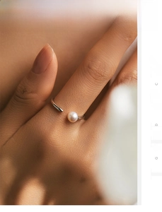 Macro shot of minimalist S925 sterling silver ring with a round white pearl on hand
