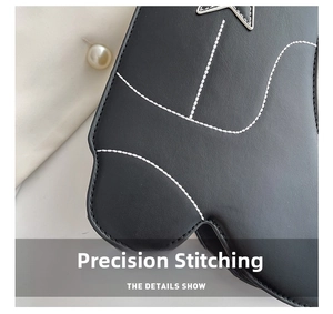 Detail shot of high-quality white contrast stitching on black leather crossbody bag