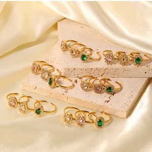 Detail of vintage gold stainless steel rings with zircon stones on silk fabric