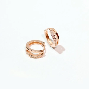 Detailed close-up of rose gold double-layered earrings with sparkling pavé zircons