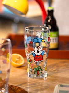 Close-up of fancy cartoon dog print on a large transparent glass beer mug with stars
