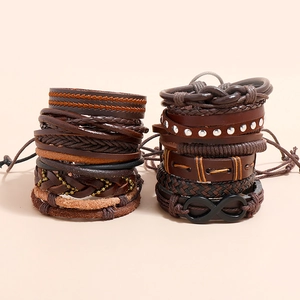 Vintage braided leather bracelet set with beads and infinity symbol on beige background