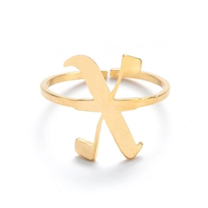 Detailed macro view of gold-plated open ring featuring a vintage engraved letter X