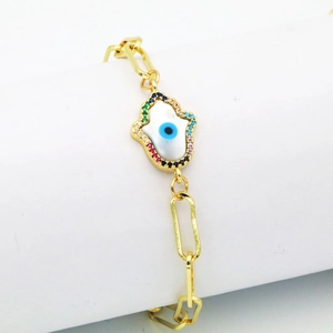 Detail of gold hamsa hand charm with evil eye and multicolor zircons on paperclip chain