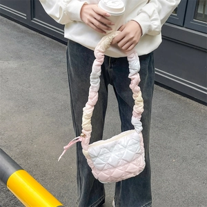 Detail of pink gradient cloud bag featuring quilted pattern and ruched shoulder strap