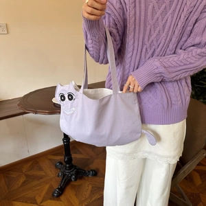 Detail of cute cat embroidery and tail design on large purple canvas tote bag