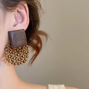 Detailed view of large square wood texture and beaded round cluster drop earrings