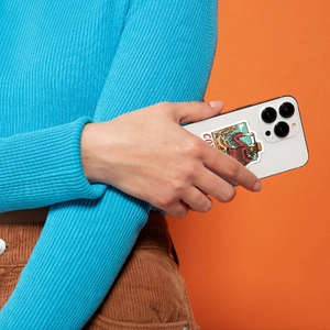 Artistic Western cowboy stickers applied to a smartphone back with bright orange background