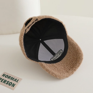 Detail view of khaki teddy fleece baseball cap with breathable black mesh lining inside