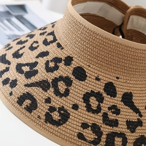Close-up of leopard print straw sun hat showing fine weave texture and pattern details